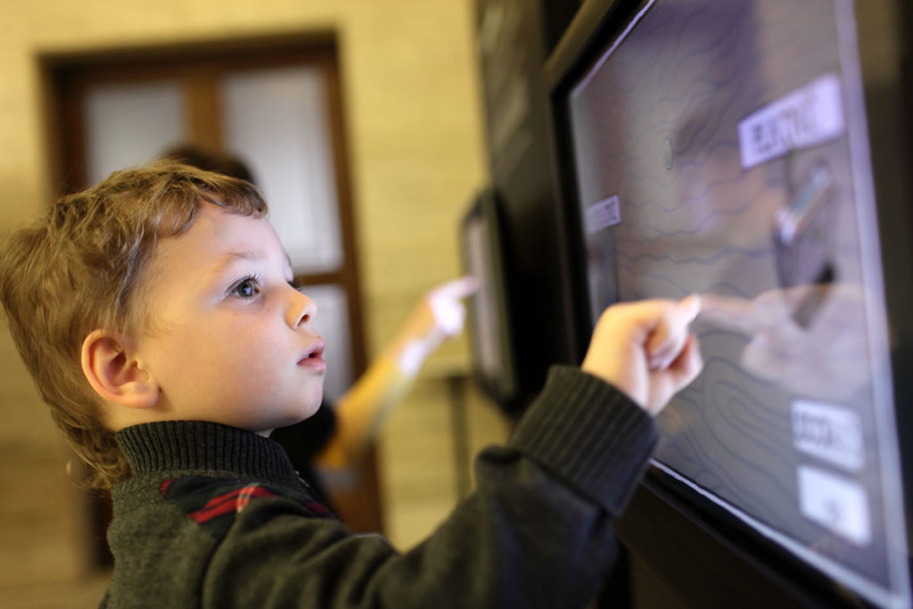 boy-using-interactive-screen